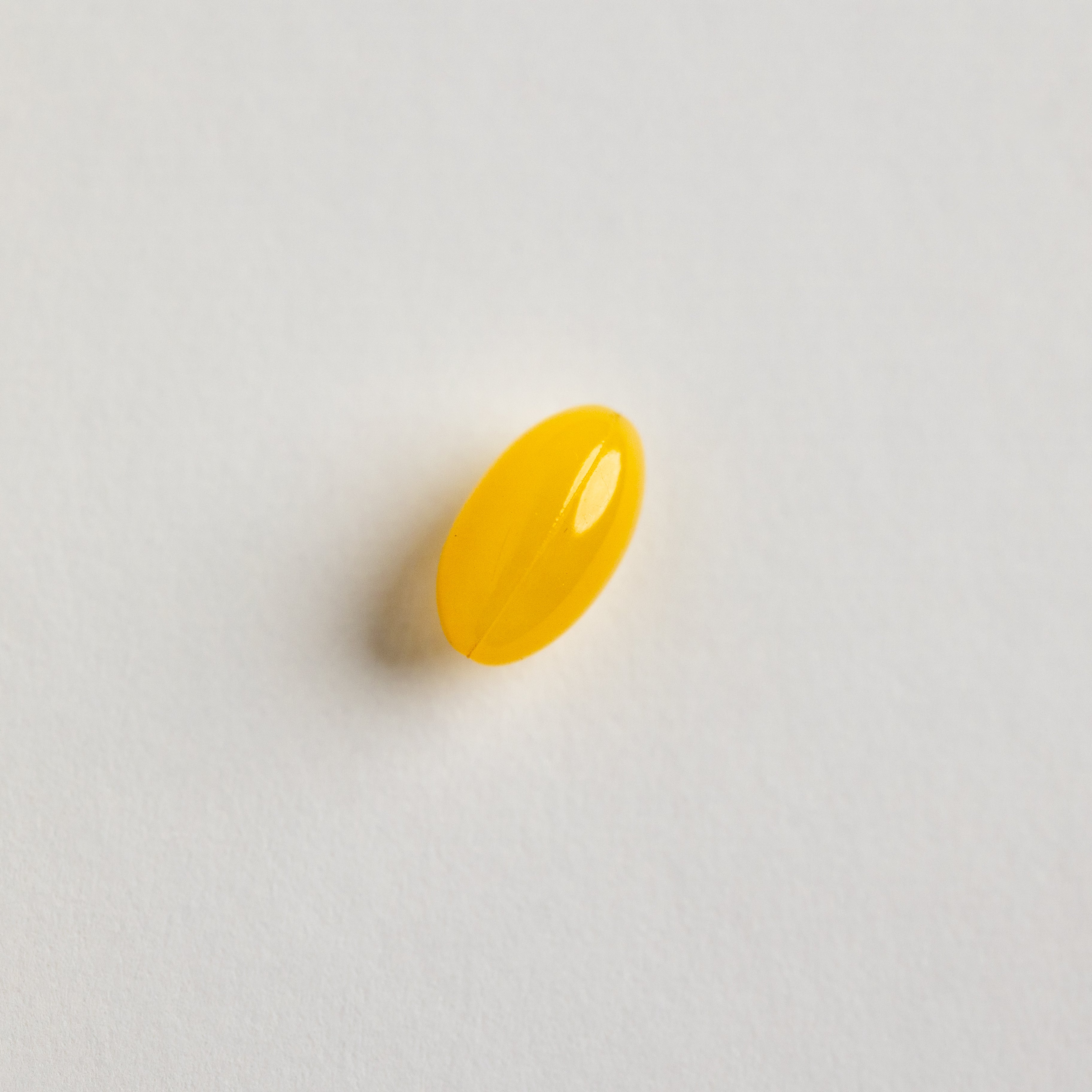 closeup of yellow gold softgel capsule